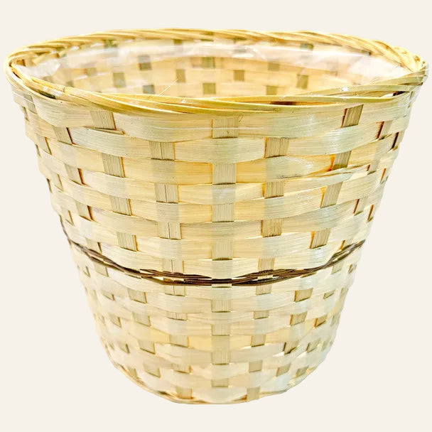 Woven basket made of light-colored material on a white background