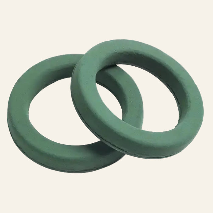 Two green ring holders on a white background