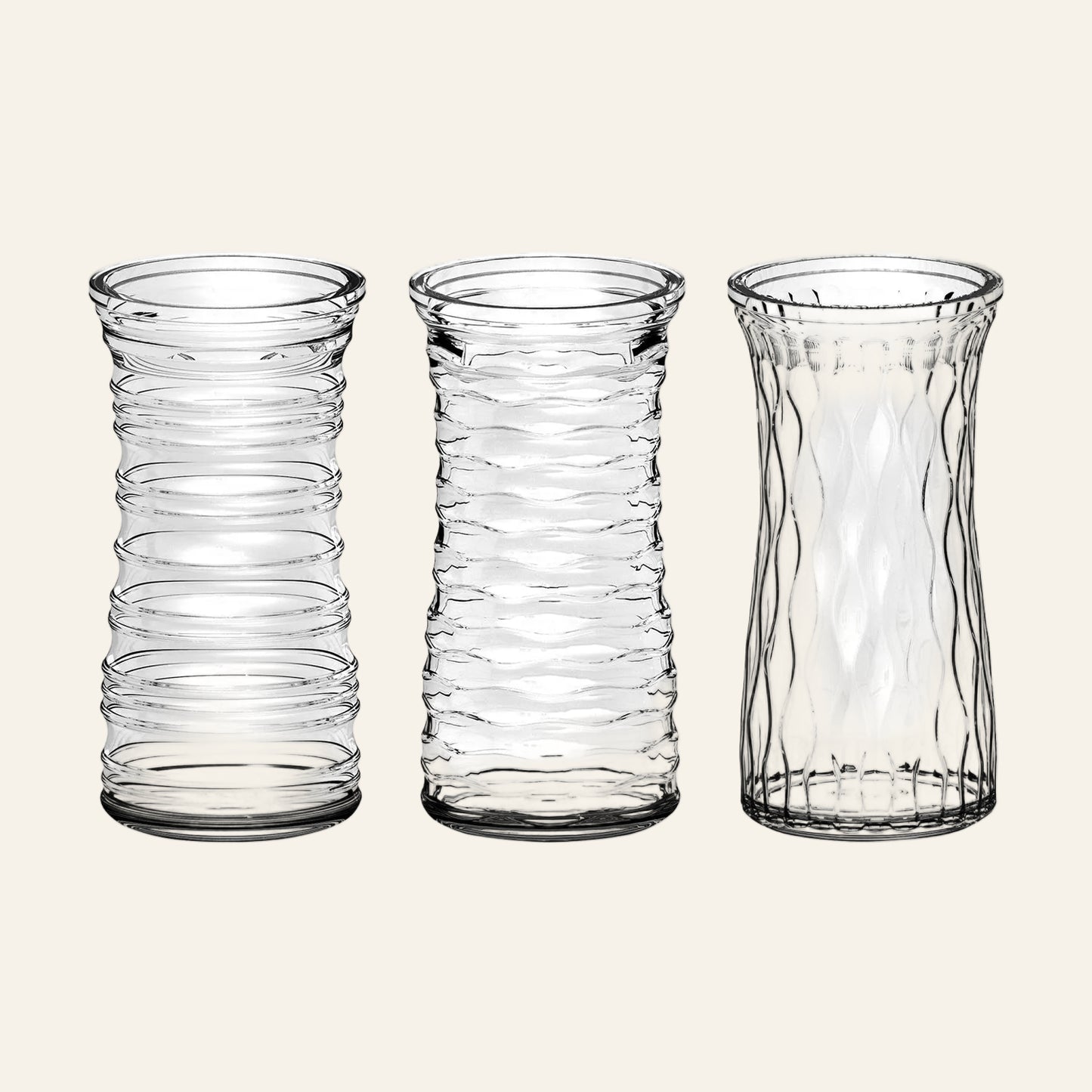 Three clear glass vases with textured design on a white background