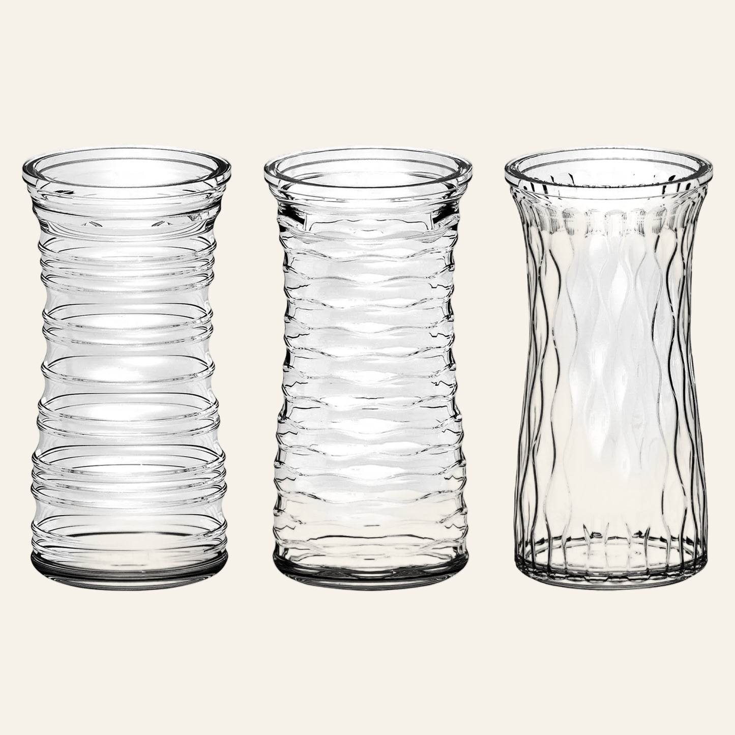 Three clear glass vases with textured designs on a white background