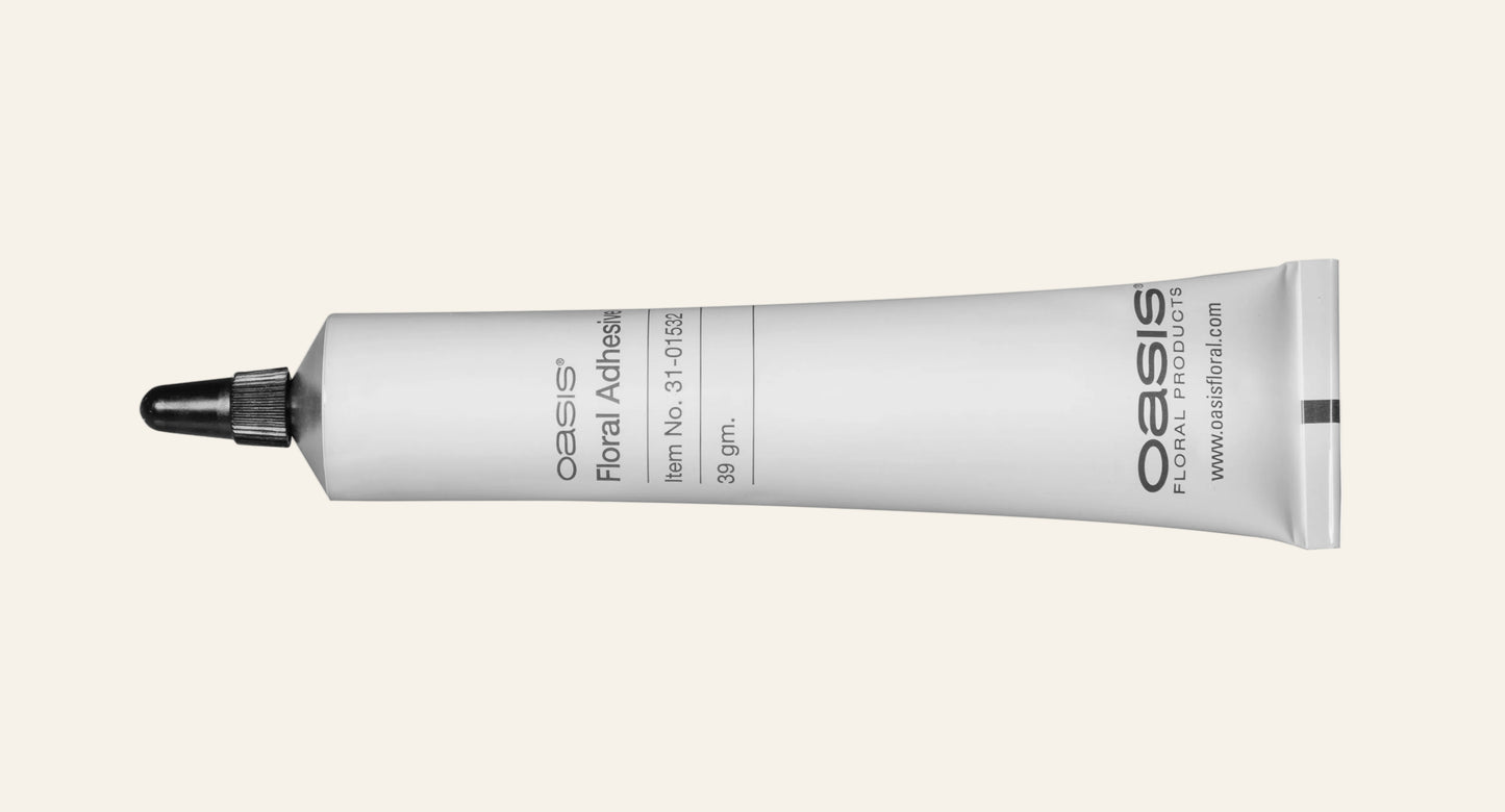 Oasis floral adhesive tube on a white background