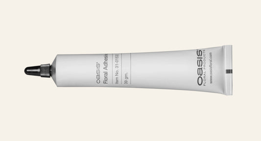 Oasis floral adhesive tube on a white background