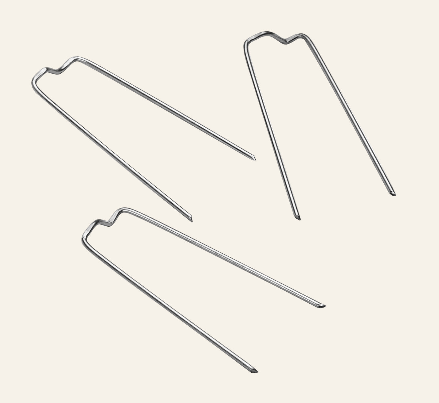 Three metal pins on a white background