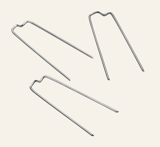 Three metal pins on a white background