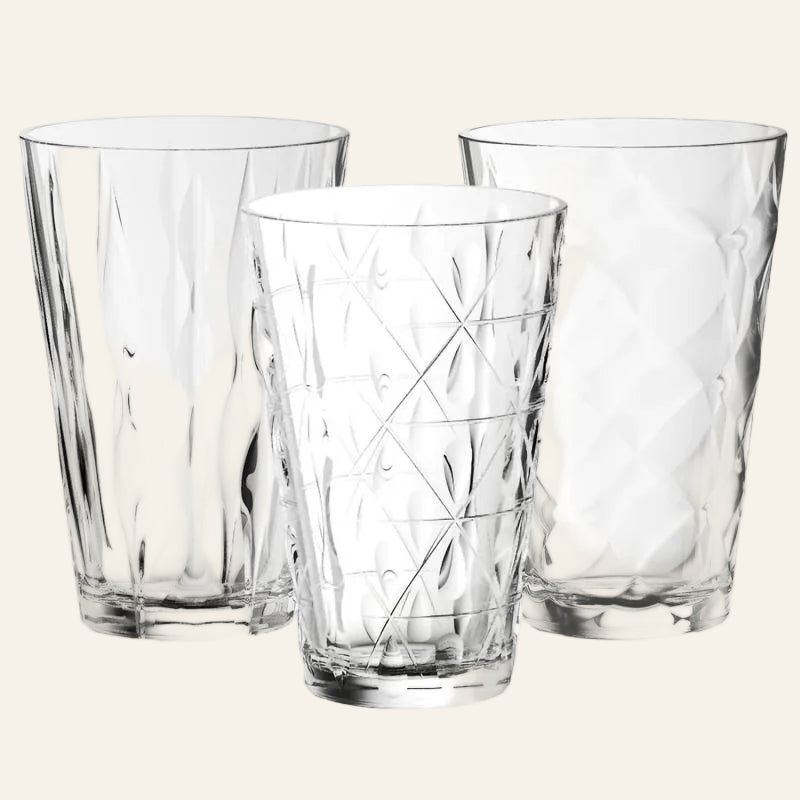 Three clear glass vases with textured designs on a white background