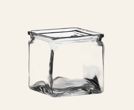 Clear glass square vase on a white background