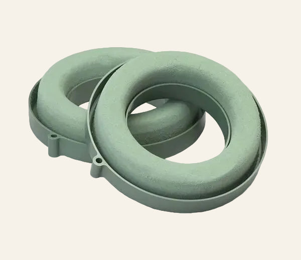 Two green aquafoam rings on a white background