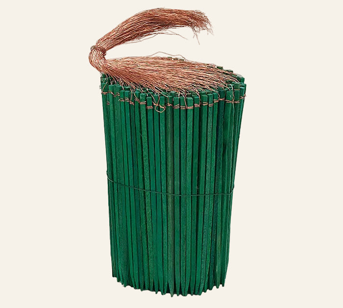 Green picks with wire on a white background