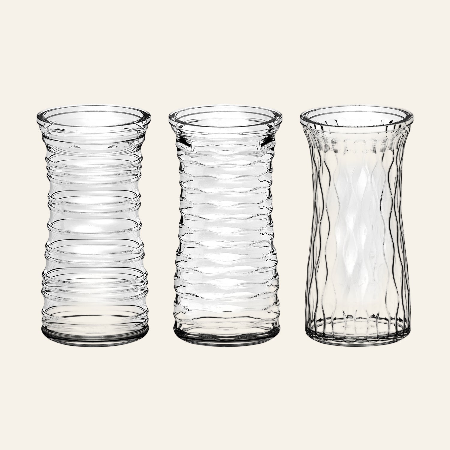 Three clear glass vases with textured design on a white background