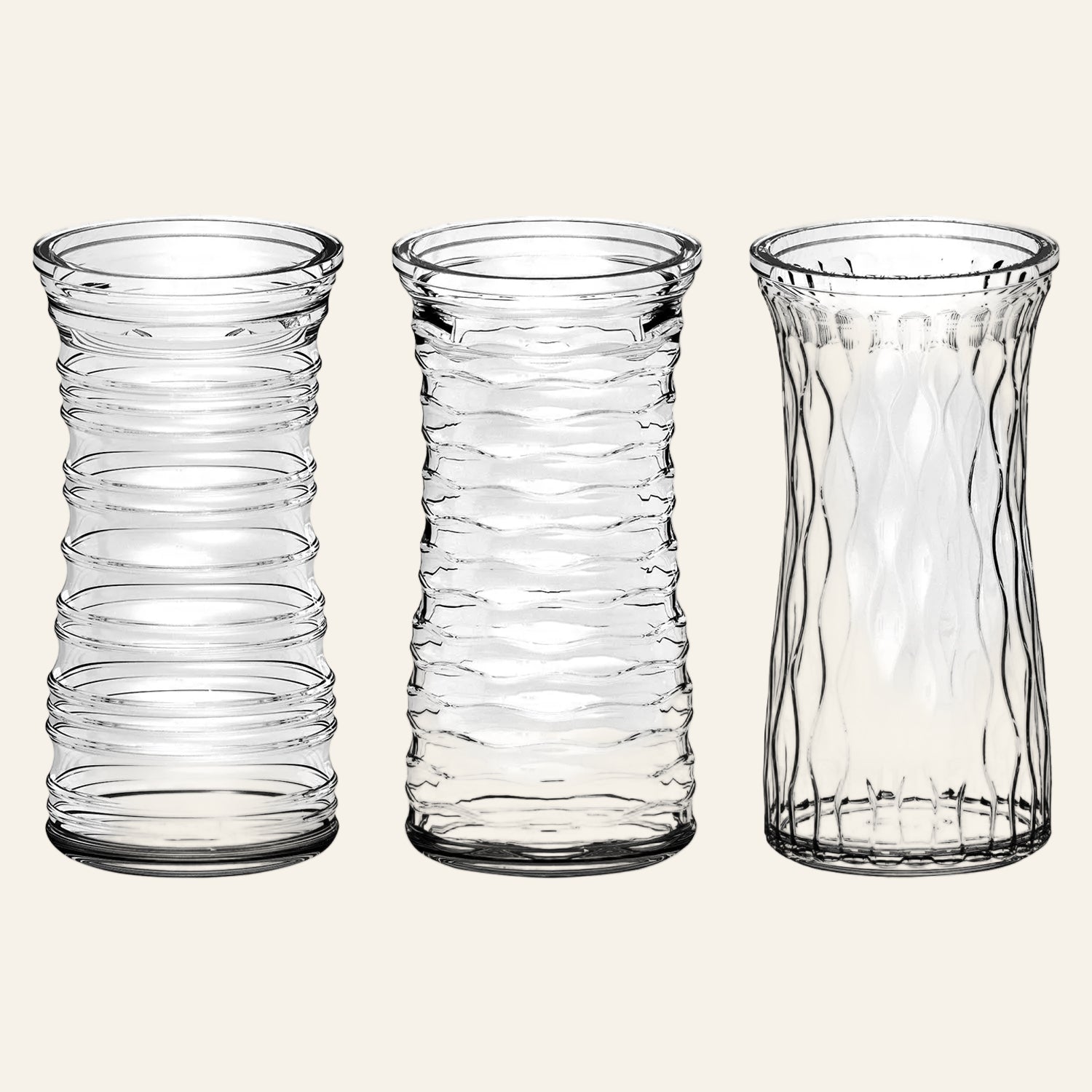 Three clear glass vases with textured designs on a white background