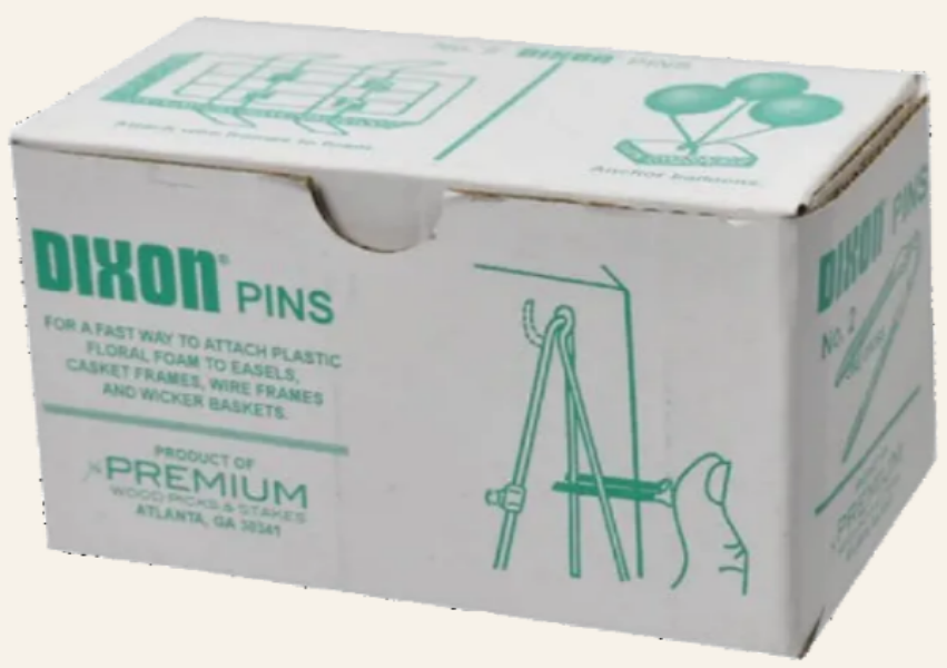 Box of Dixon pins with green text and illustrations on a white background