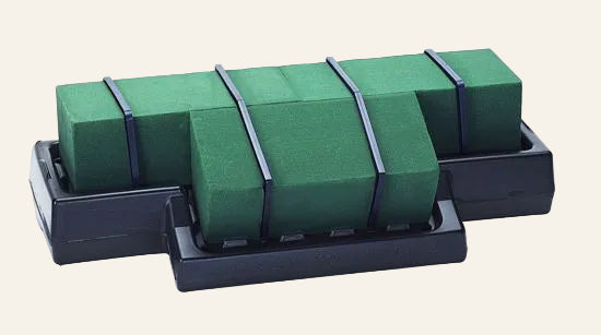 Set of green foam on a black stand against a white background