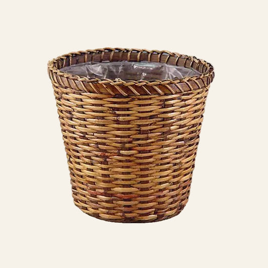 Wicker trash can with a white background
