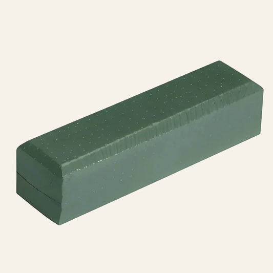 Green rectangular foam block with textured surface on a white background