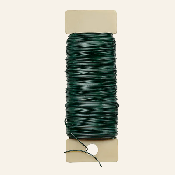 Spool of green wire on a white background